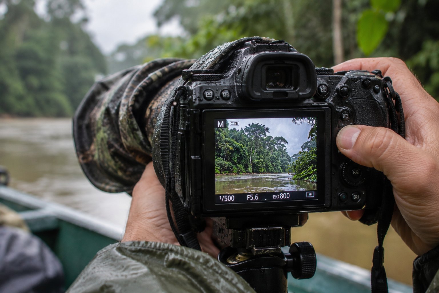 Camera gear protected by a rain cover and dry bag during an Amazon river expedition